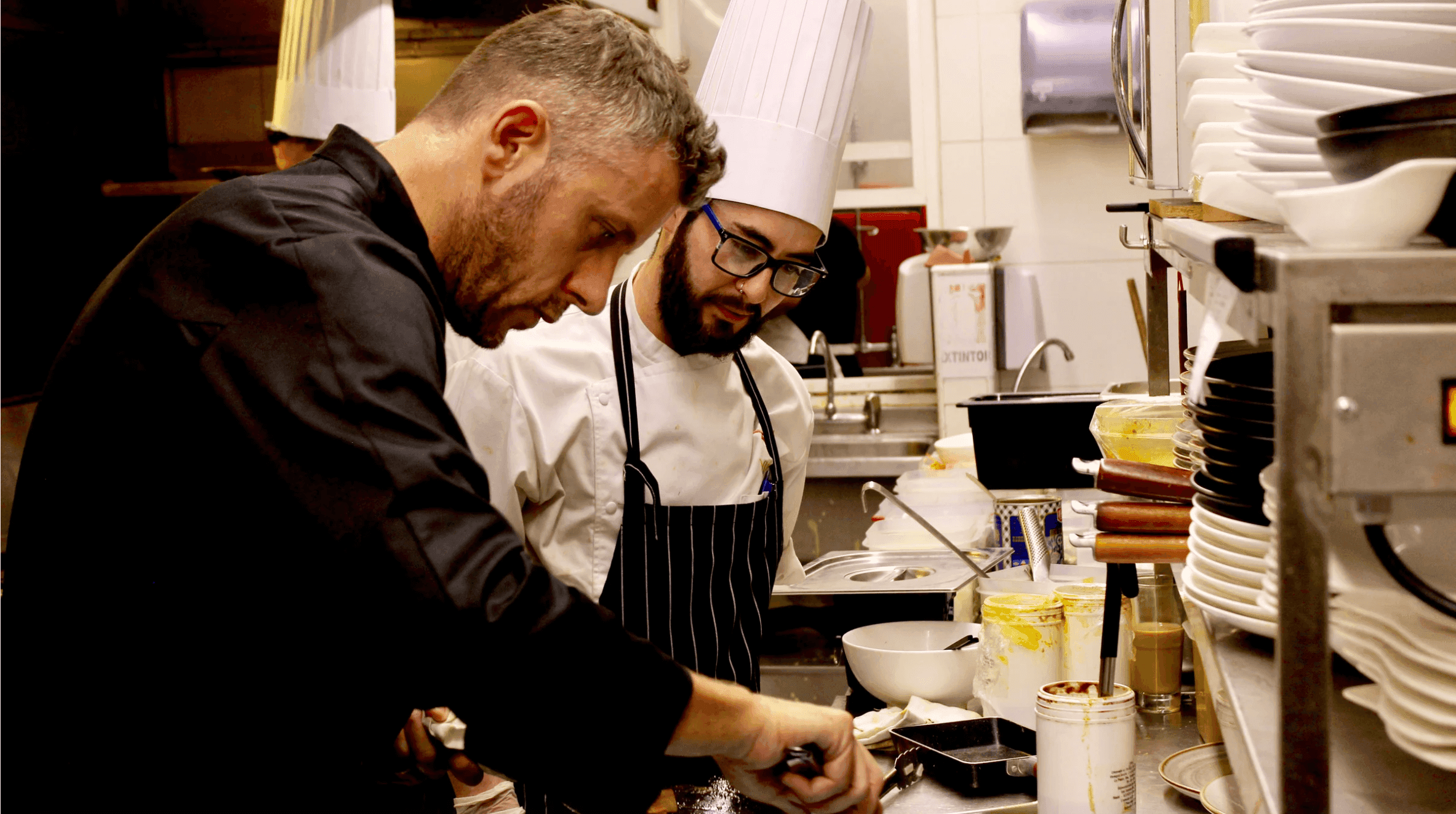 Professional chefs working together in kitchen